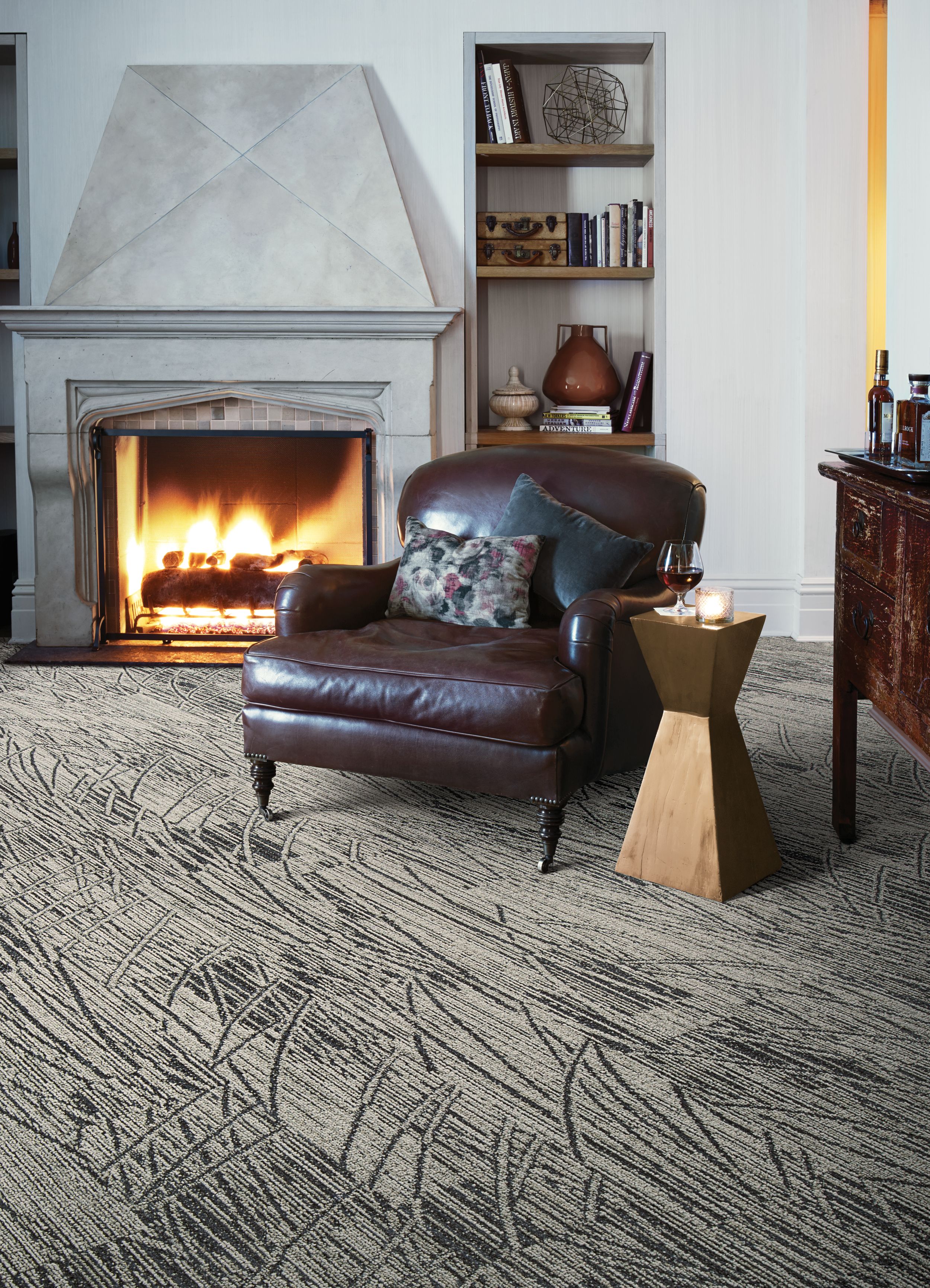 Interface WE152 plank carpet tile in sitting area with fireplace and large leather chair imagen número 2